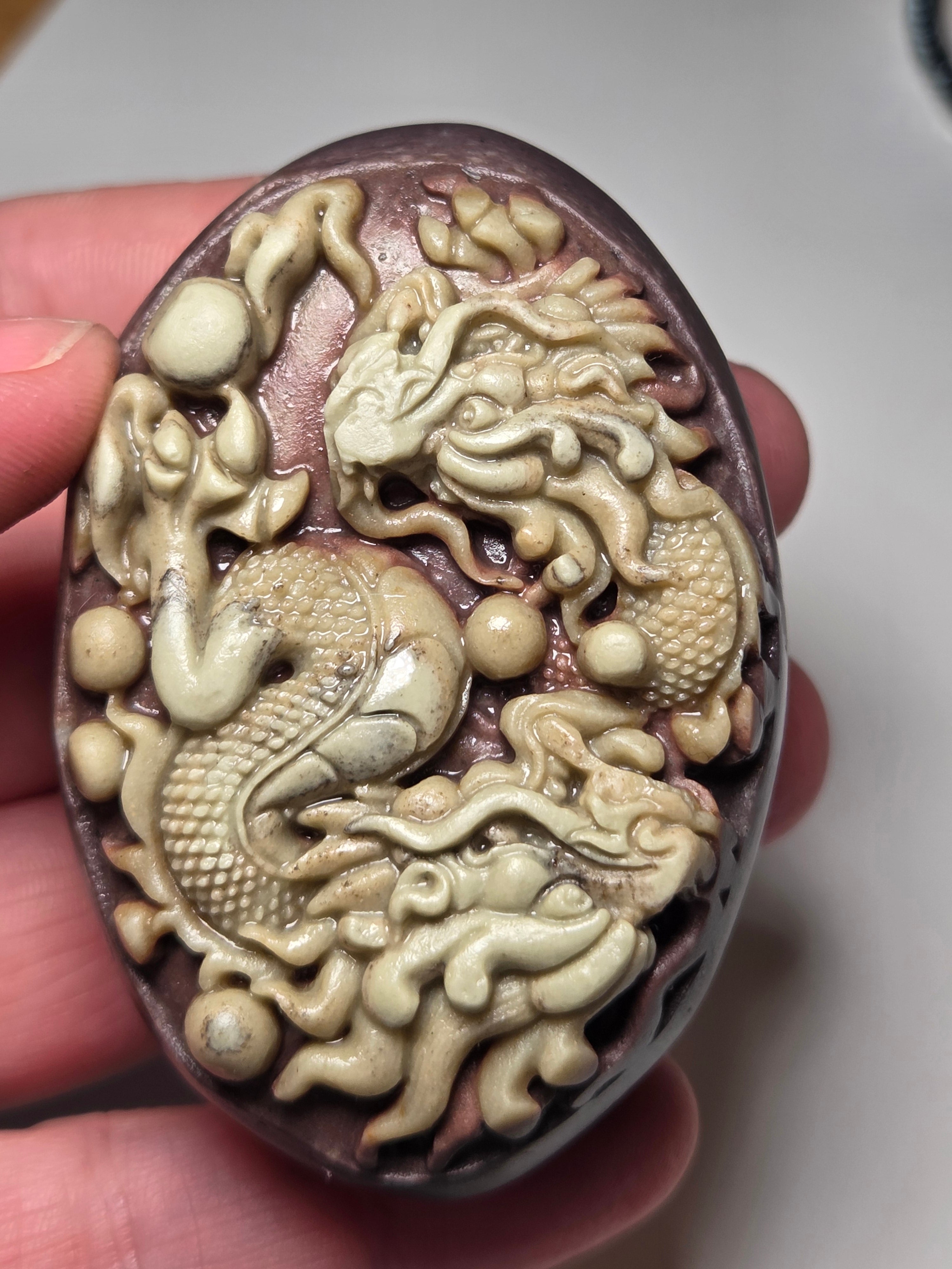 Handmade carved dragon palm stone in purple jade from Province