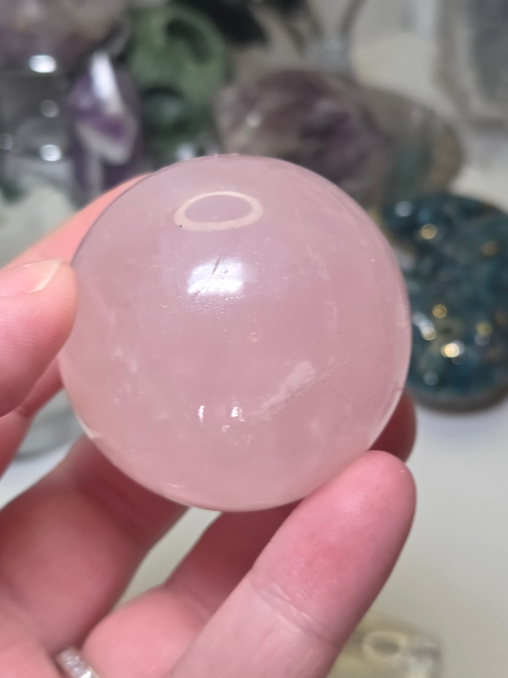 Rose quartz crystal sphere with  crack line and star flash