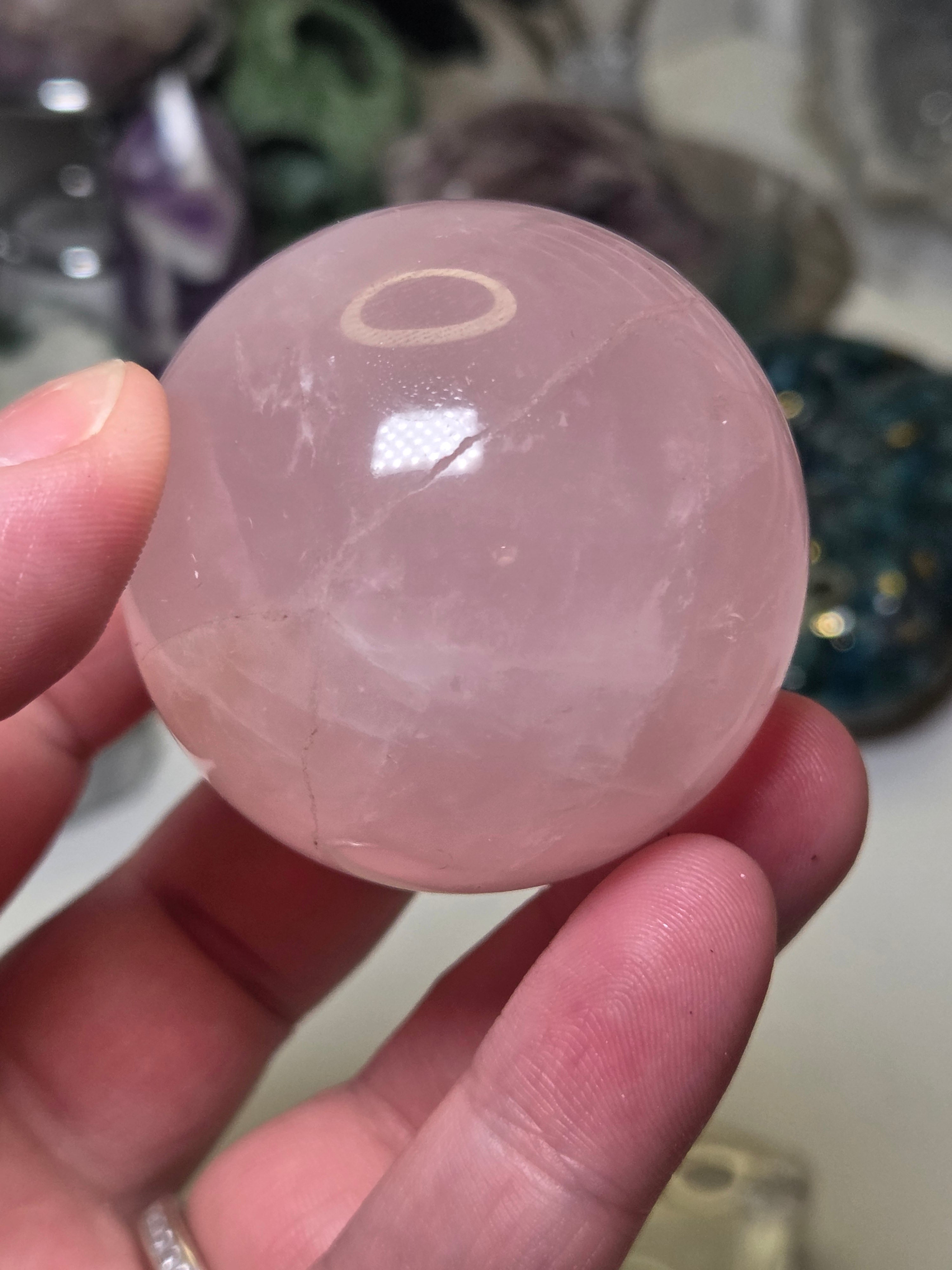 Rose quartz crystal sphere with  crack line and star flash