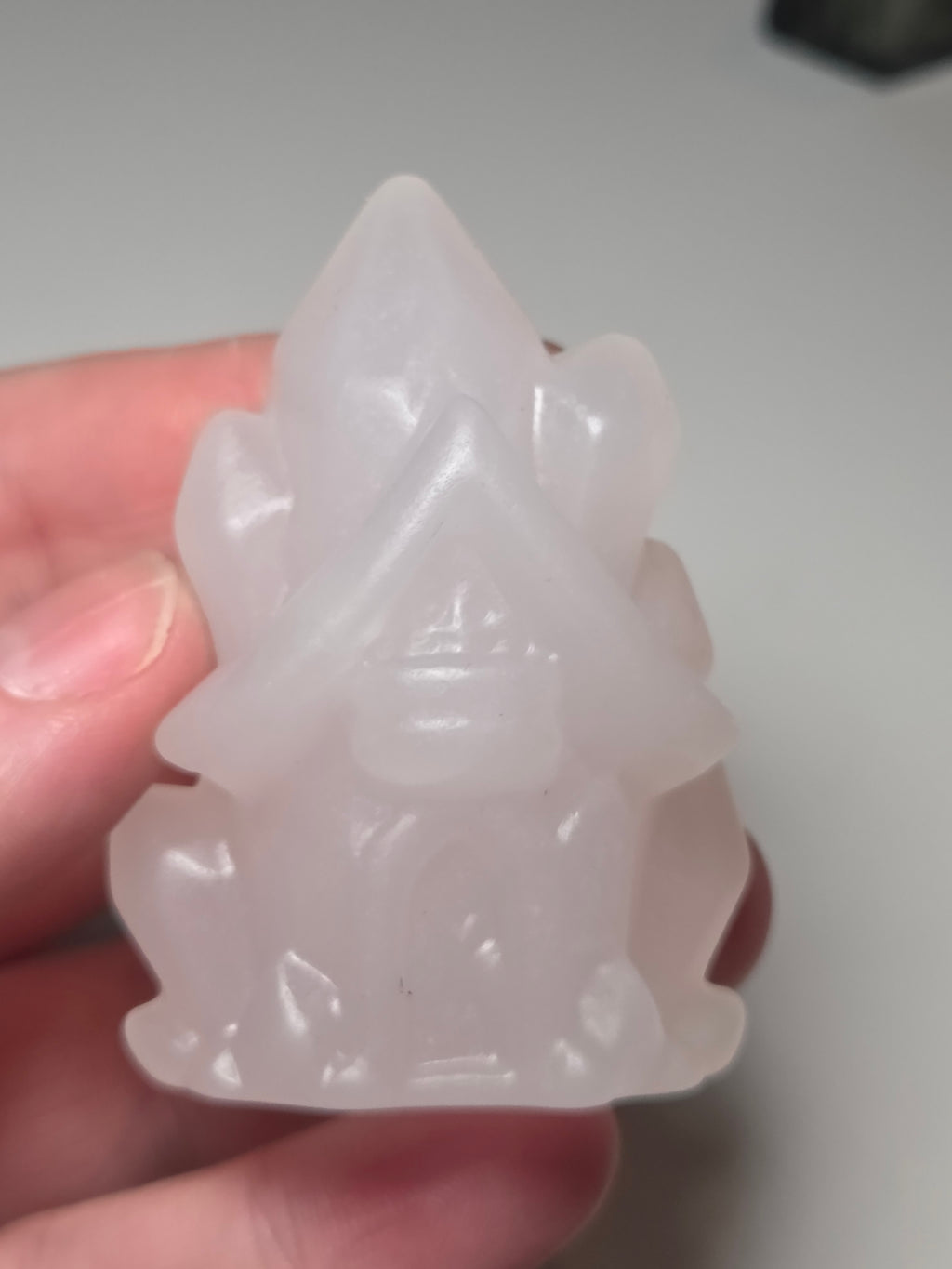Pink calcite crystal cluster  house carving