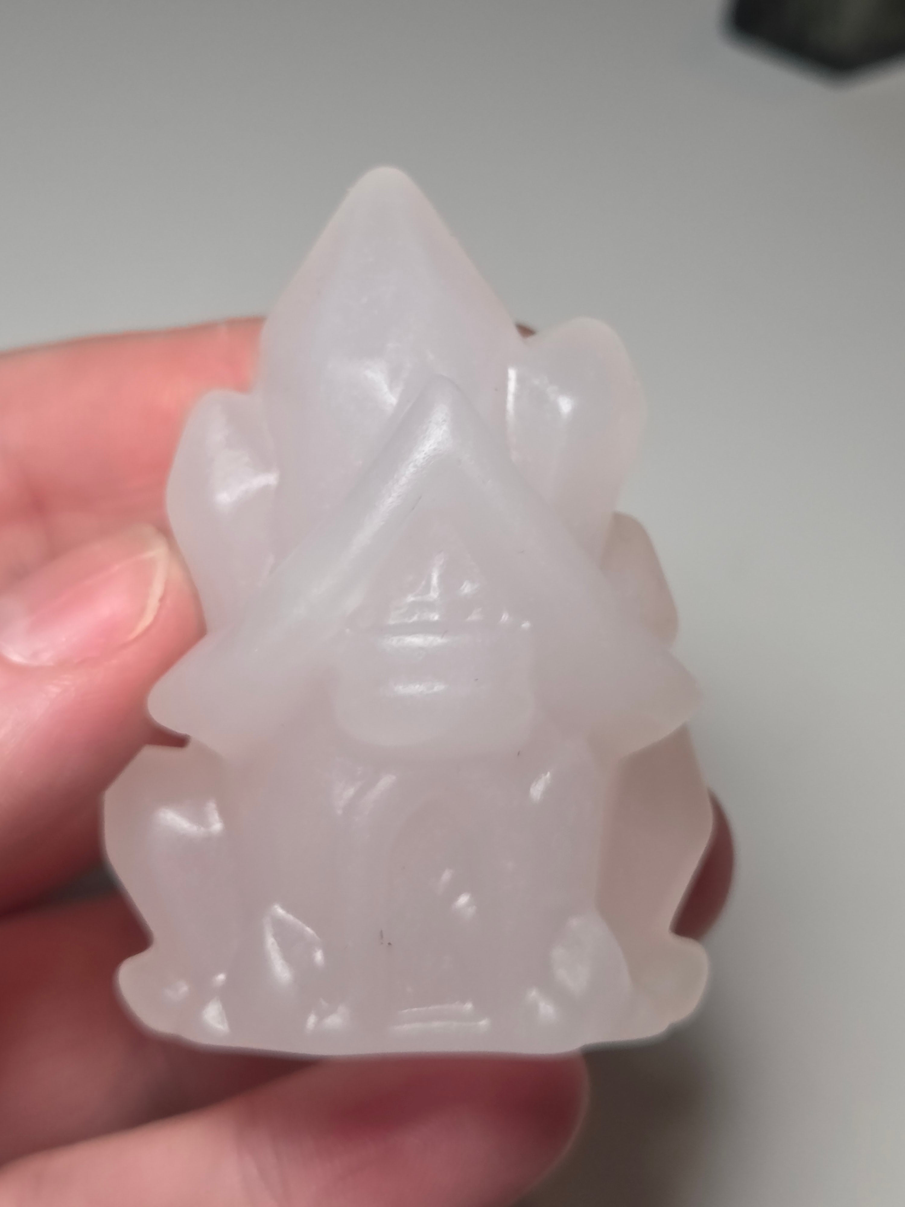 Pink calcite crystal cluster  house carving