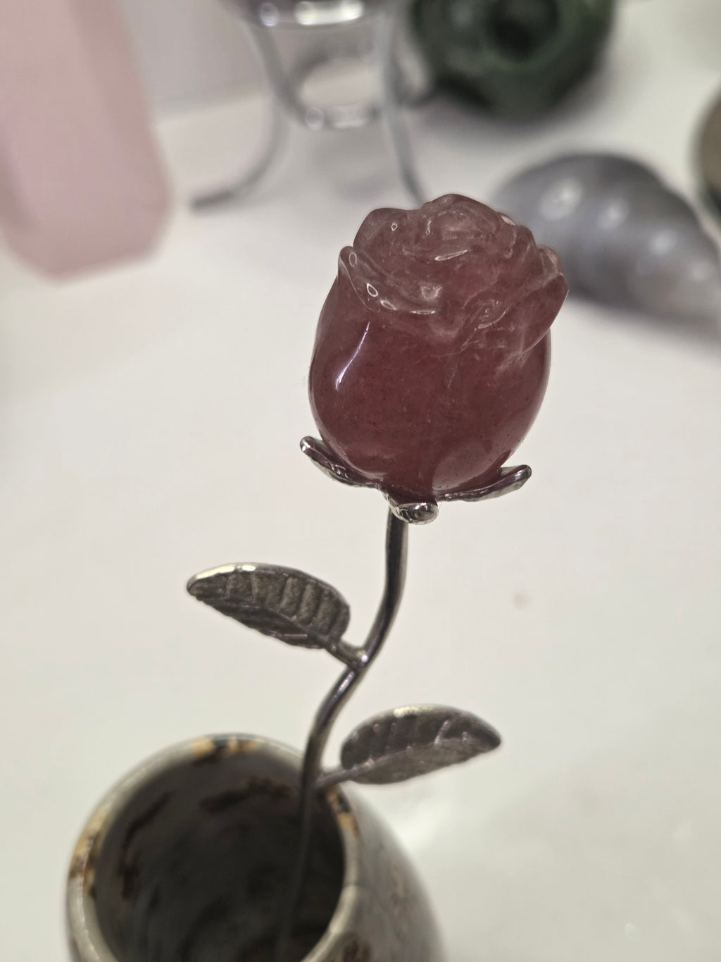Strawberry quartz crystal rose carving on a stem