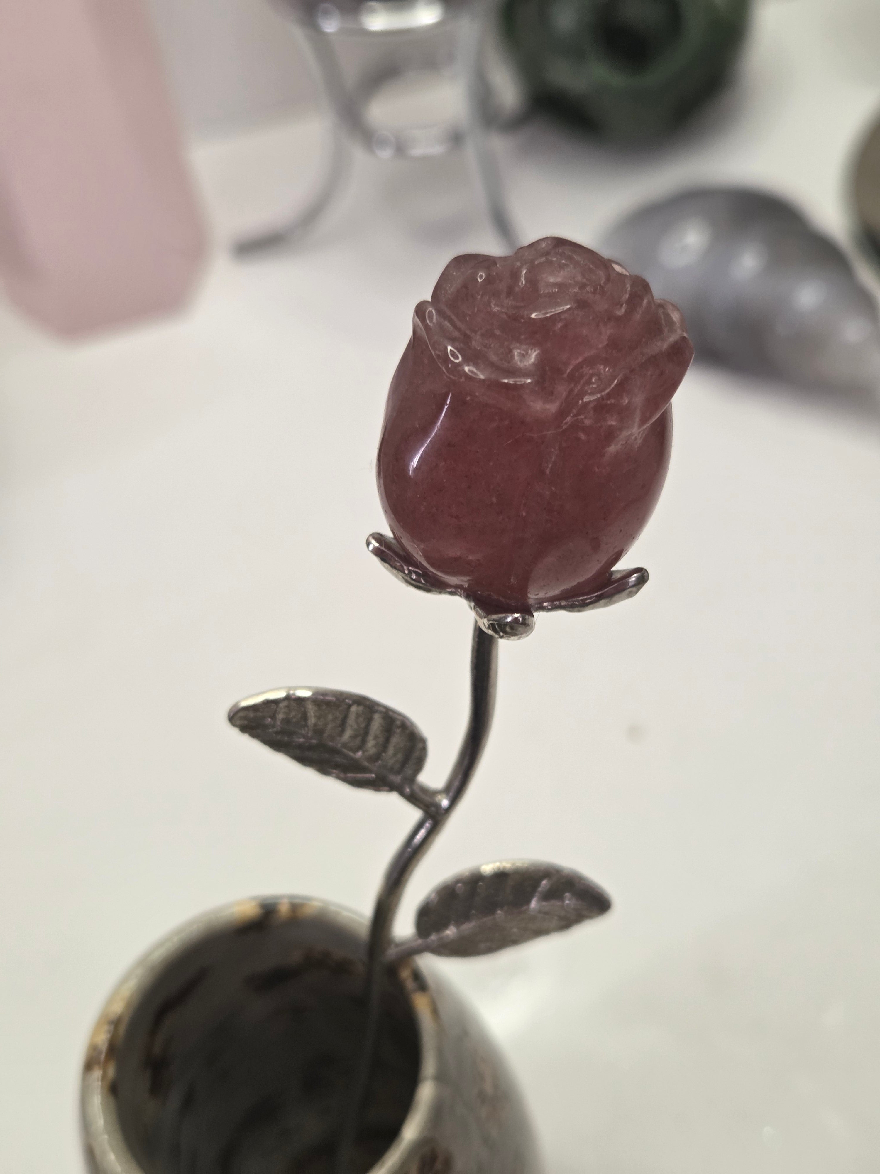 Strawberry quartz crystal rose carving on a stem