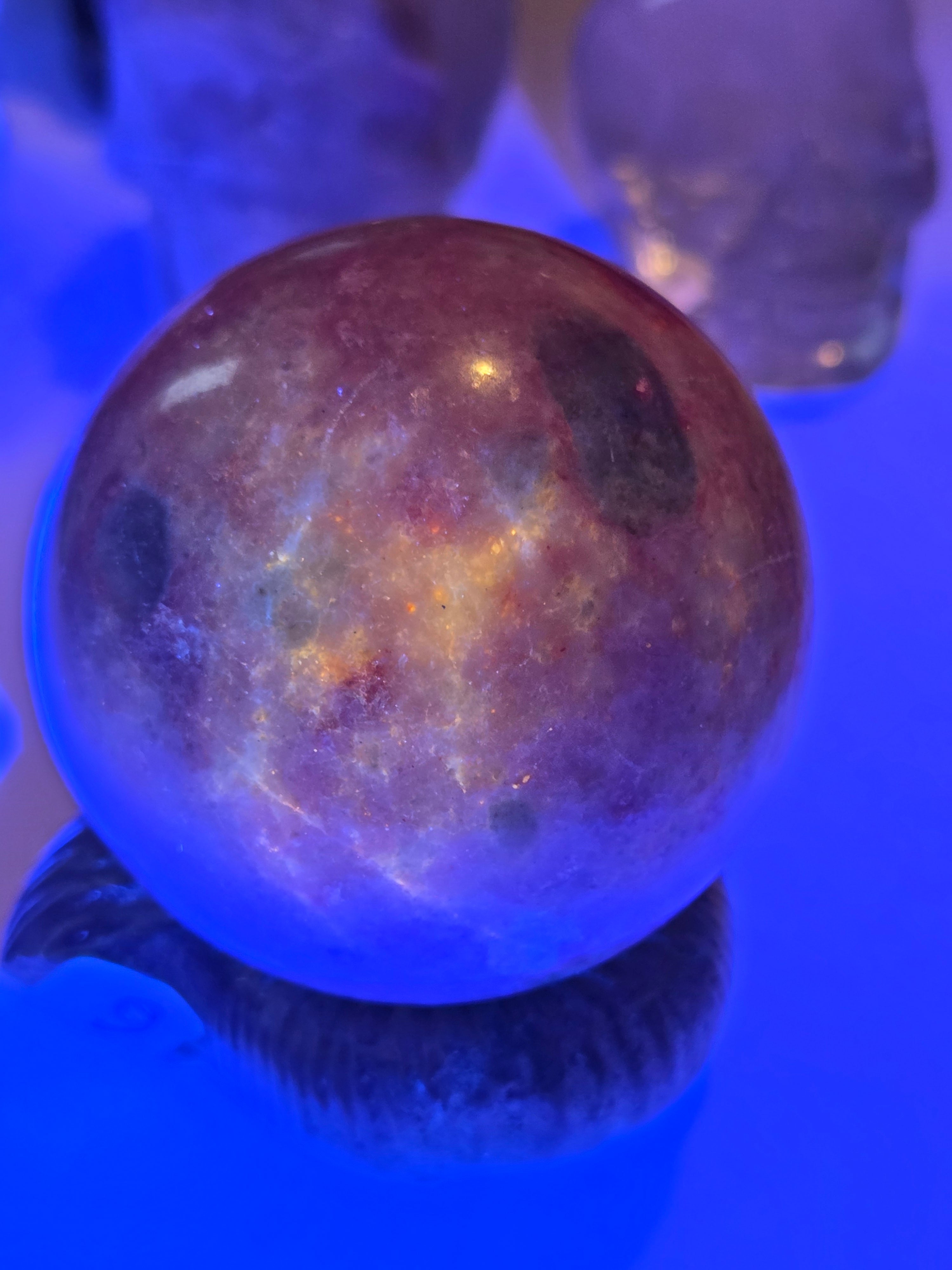 Pink zoisite crystal sphere carving with UV and comes with Stand