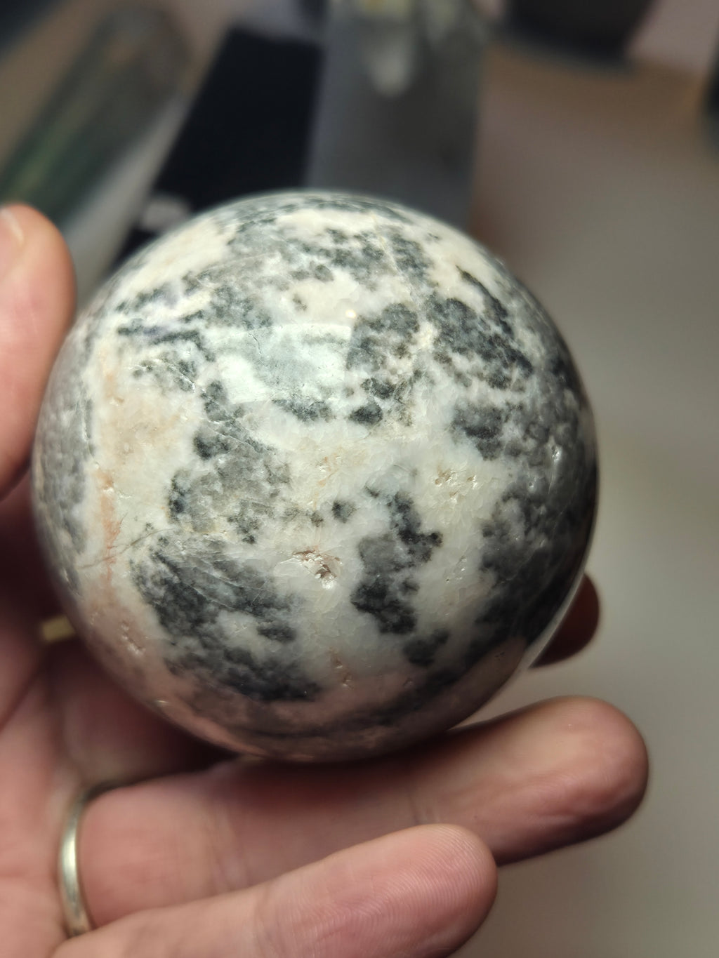 Pink rhodonite crystal sphere