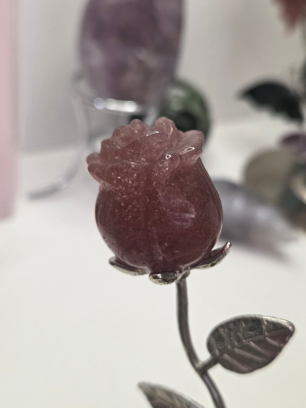 Strawberry quartz crystal rose carving on a stem