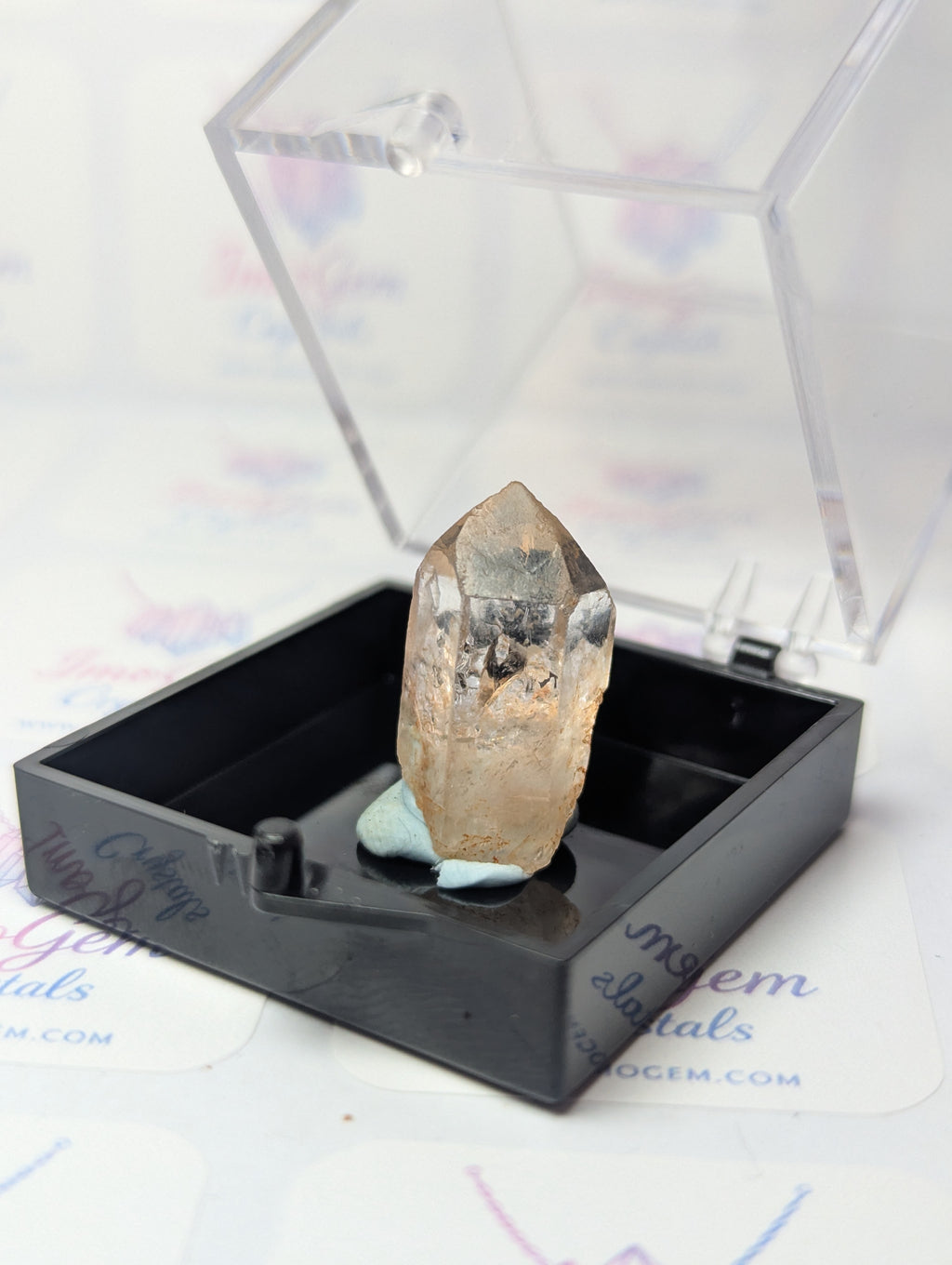 Raw quartz crystal specimen with box