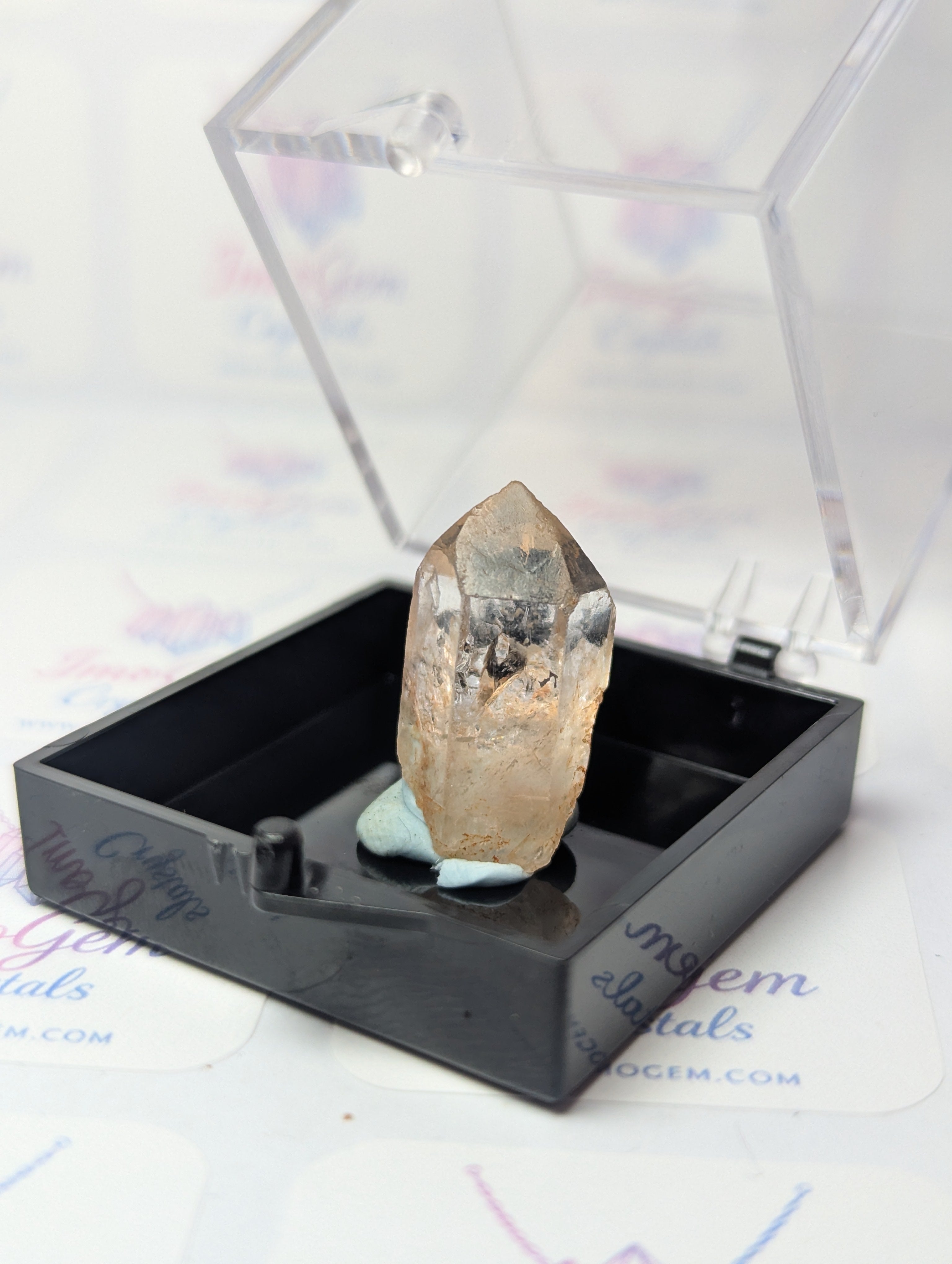 Raw quartz crystal specimen with box