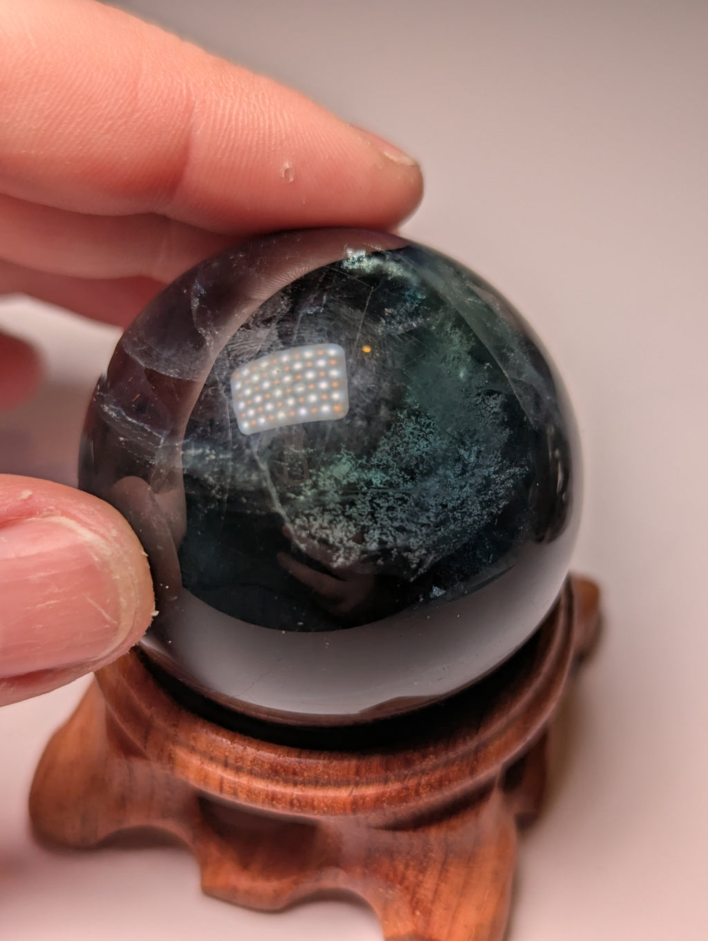 Black flourite crystal sphere with red UV with stand