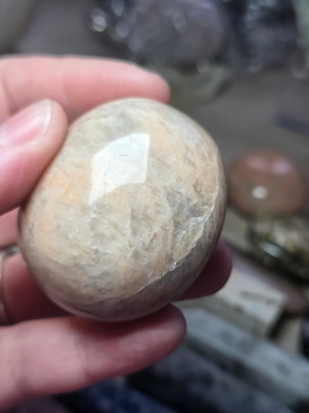 Peach moonstone crystal palm stone with imperfections
