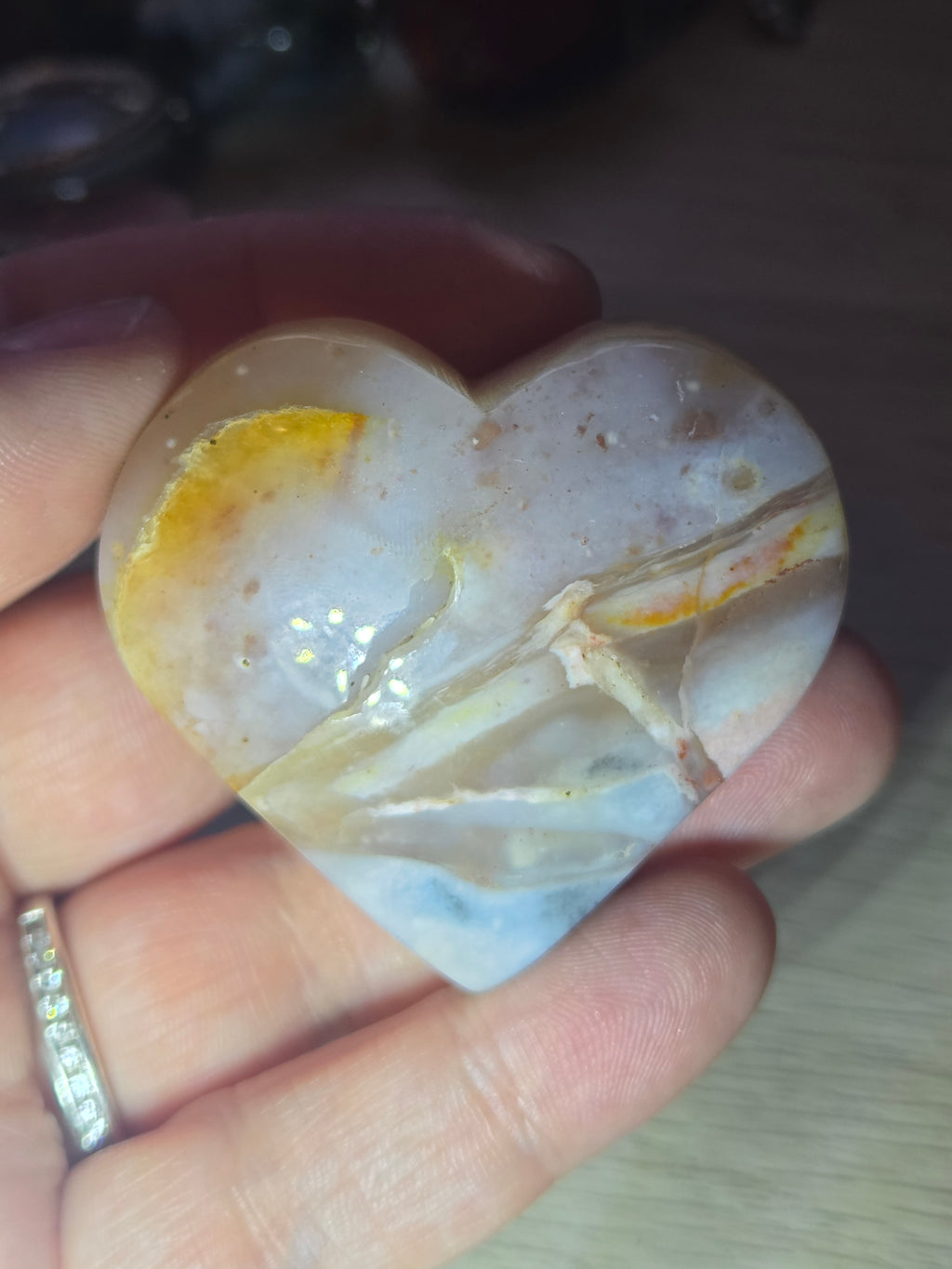 Pink petrified wood heart carving with UV