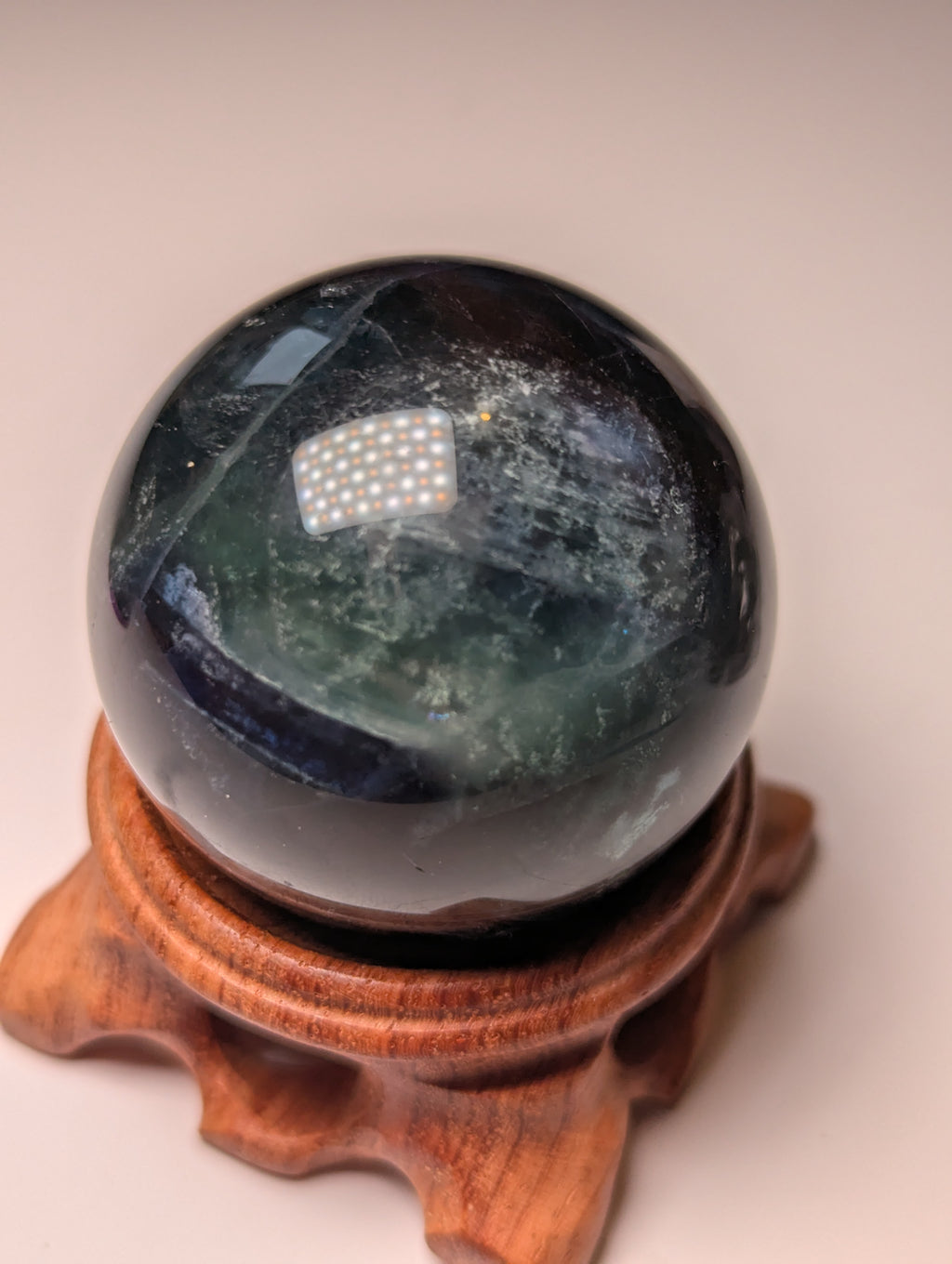 Black flourite crystal sphere with red UV with stand