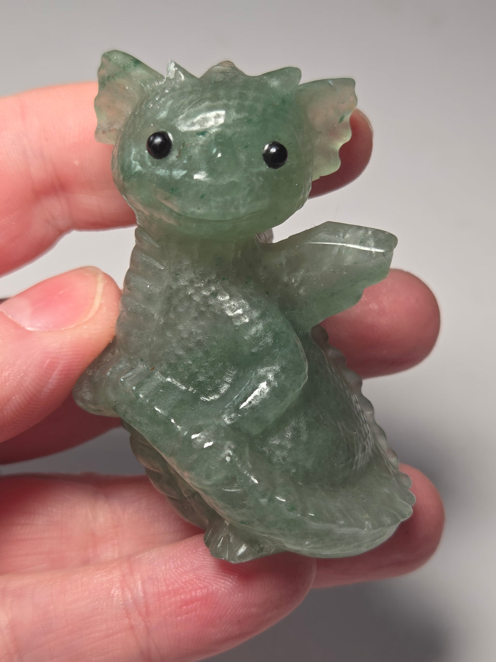 Baby dragon holding tail