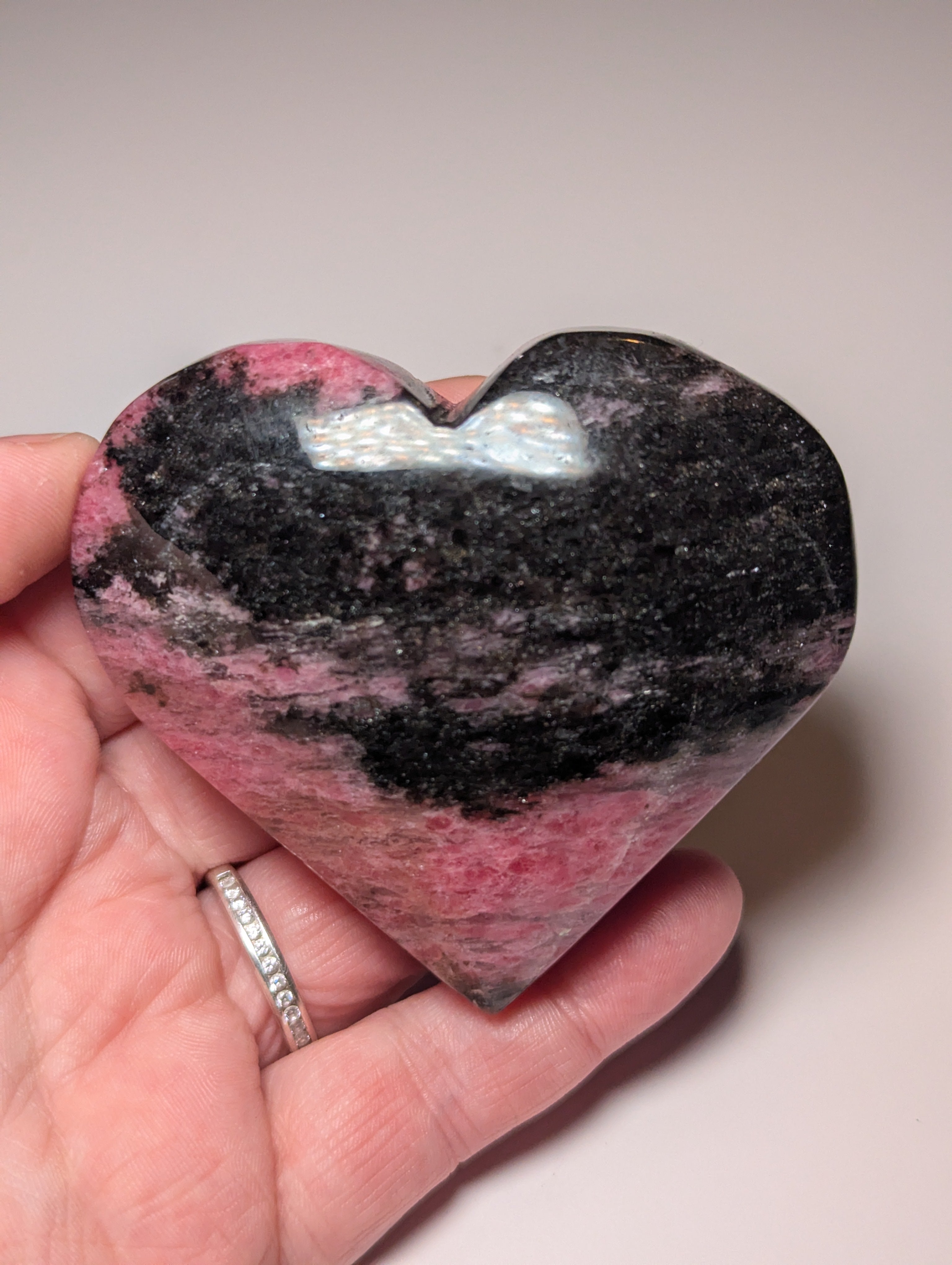 Large Rhodonite crystal heart carving with stand
