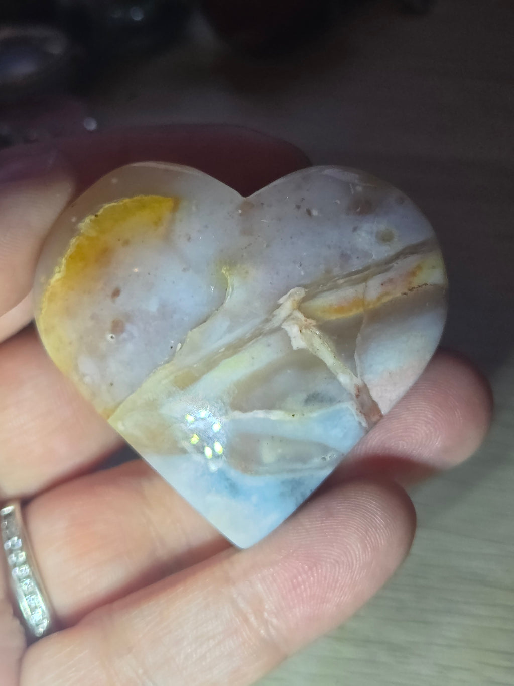 Pink petrified wood heart carving with UV