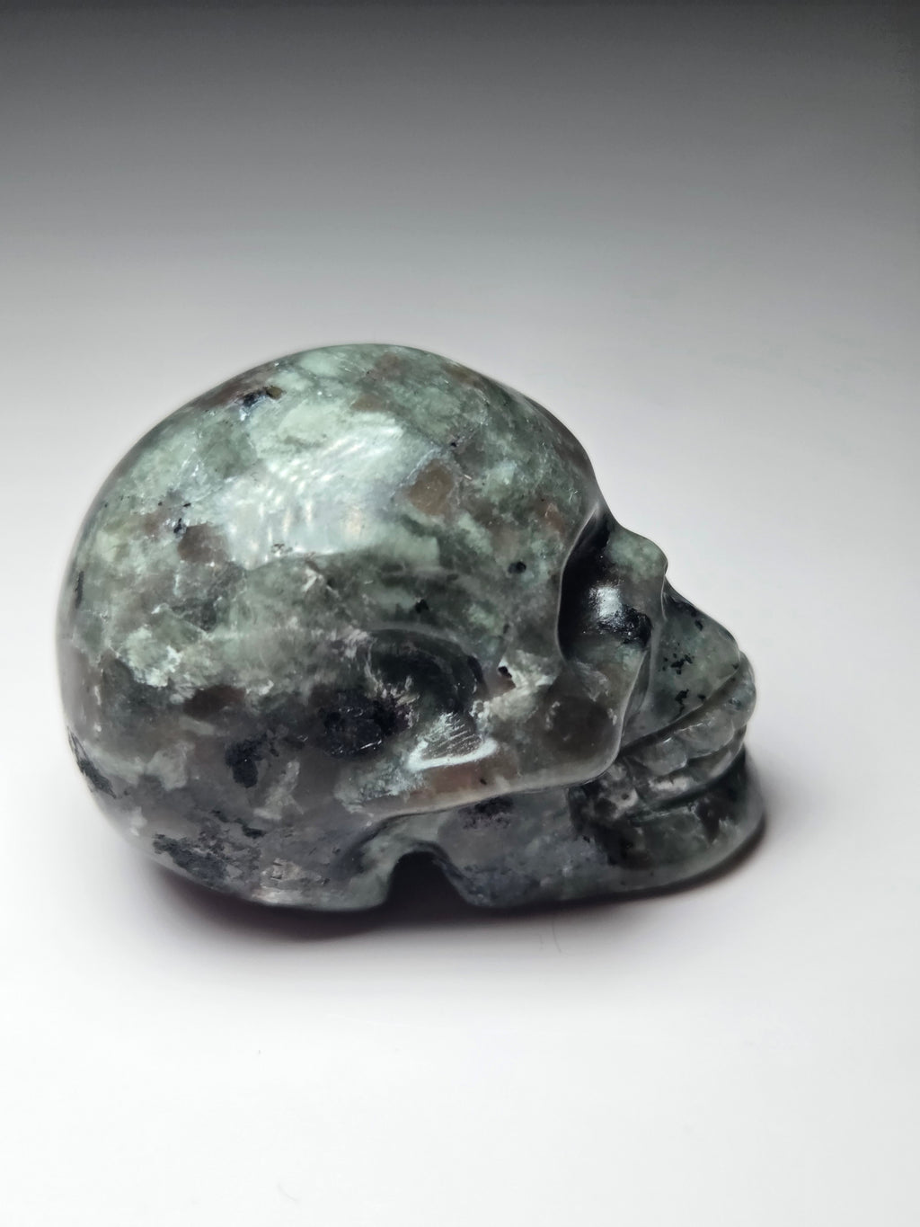 Yooperlite crystal skull carving with orange uv