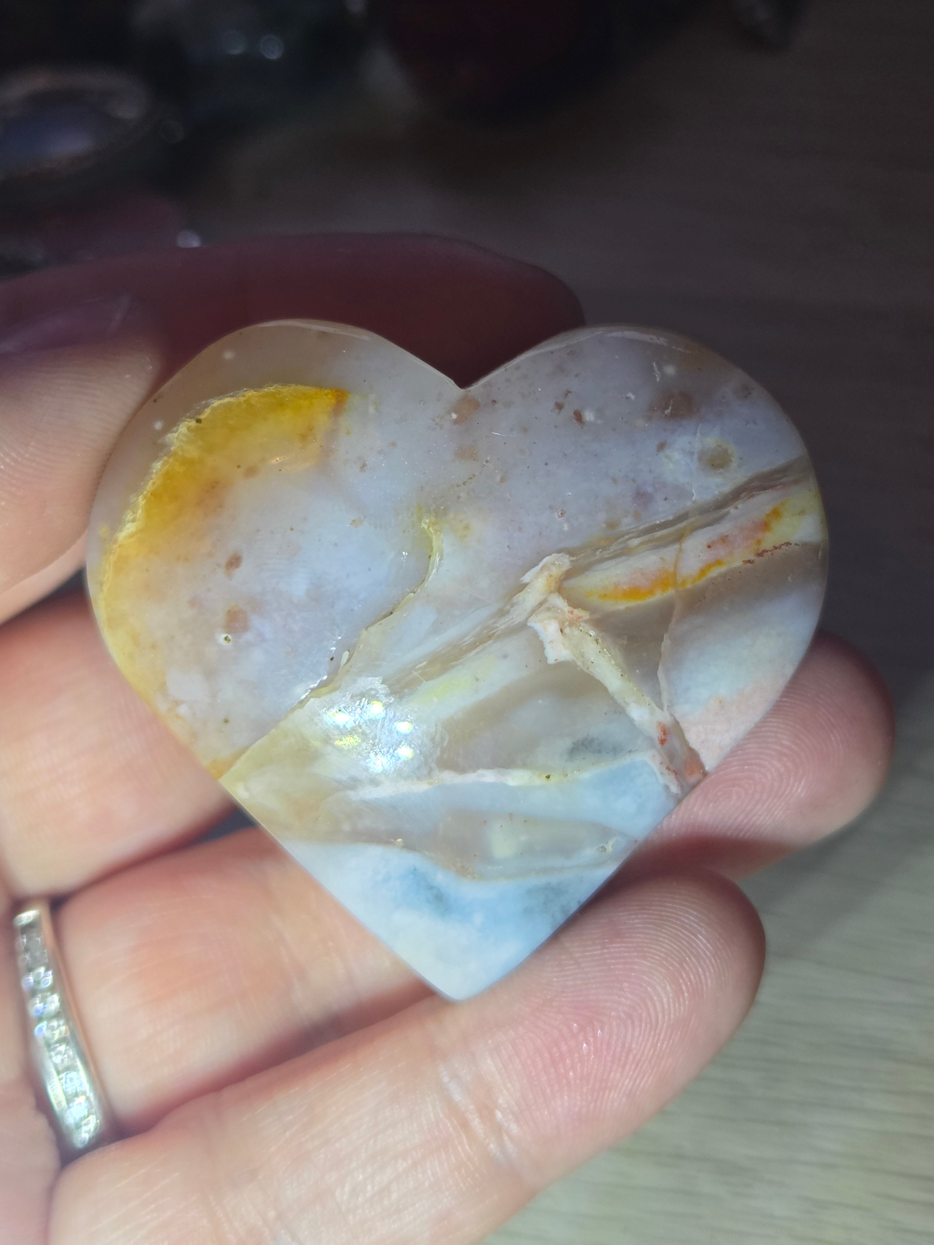 Pink petrified wood heart carving with UV