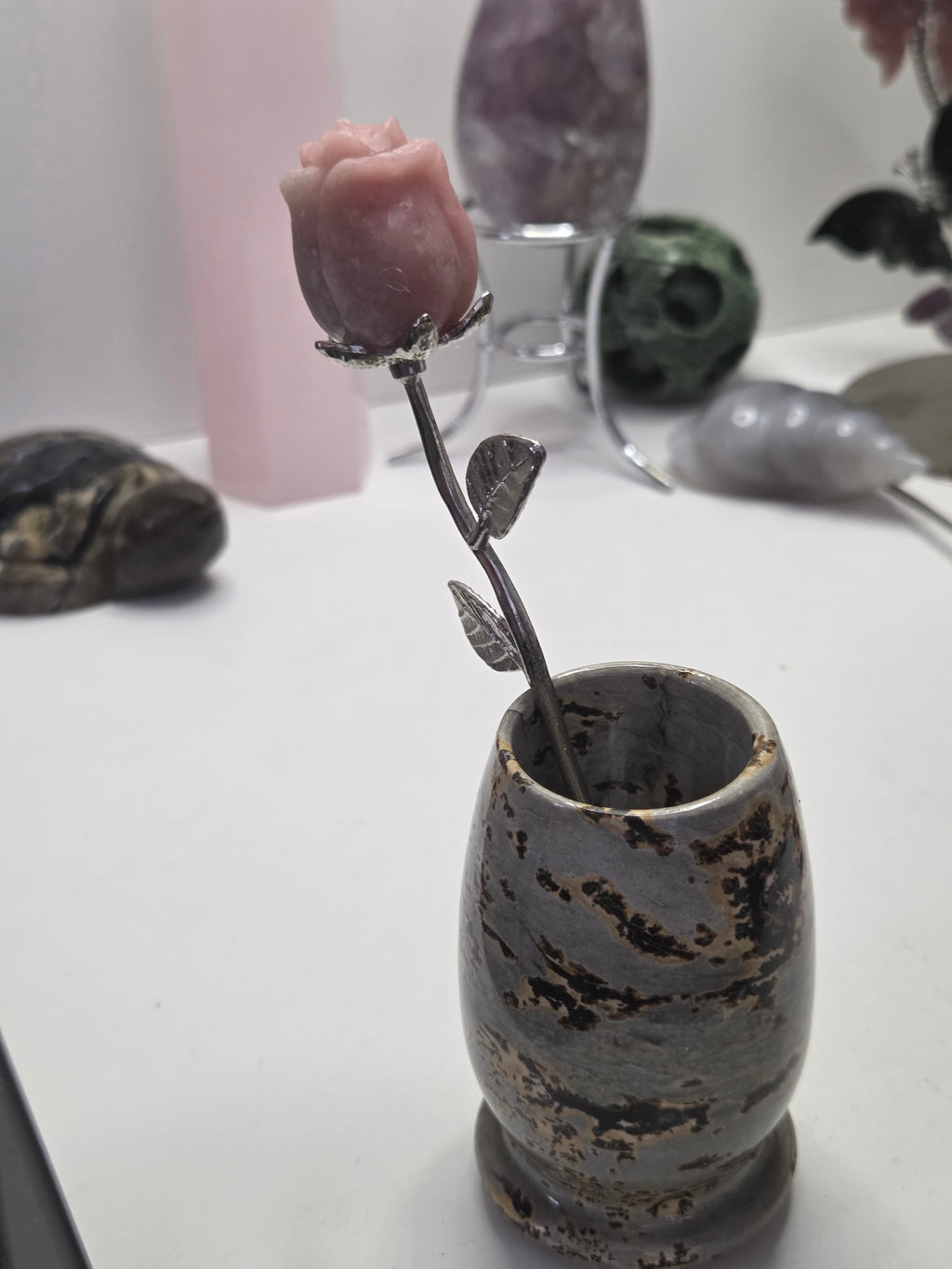 Pink opal crystal rose carving on a stem