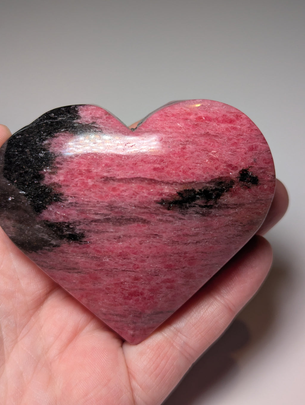 Large Rhodonite crystal heart carving with stand