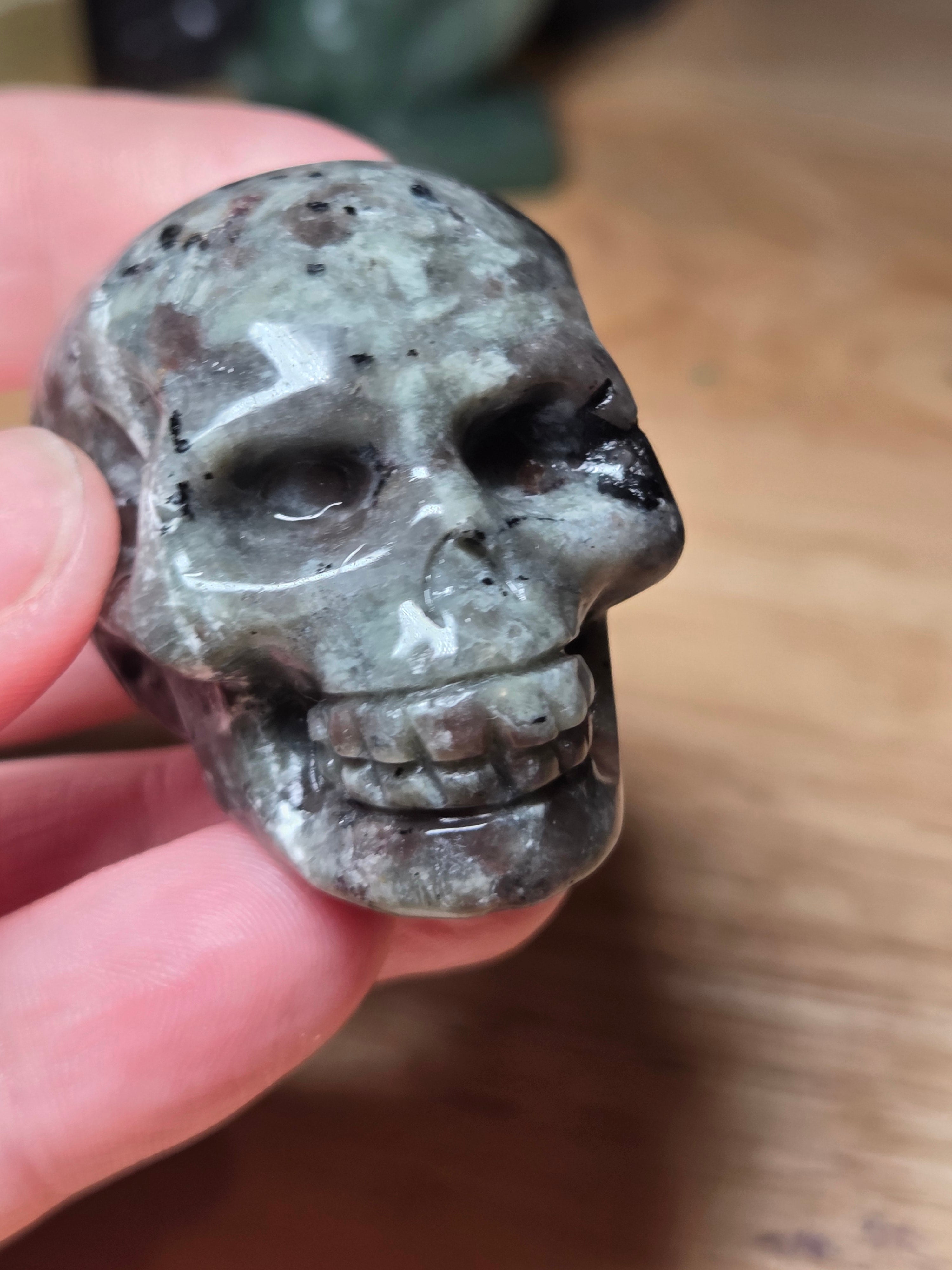 Yooperlite crystal skull carving with orange uv