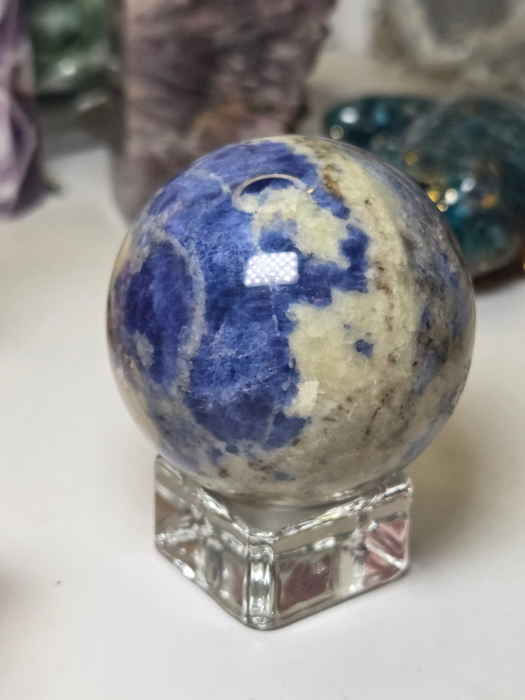Sodalite crystal sphere carving with stand