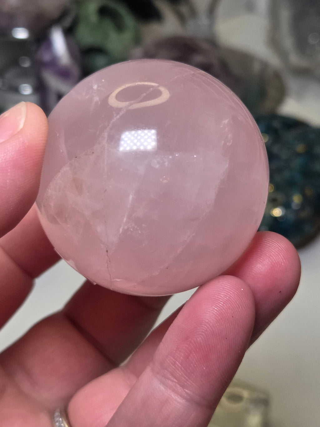 Rose quartz crystal sphere with  crack line and star flash