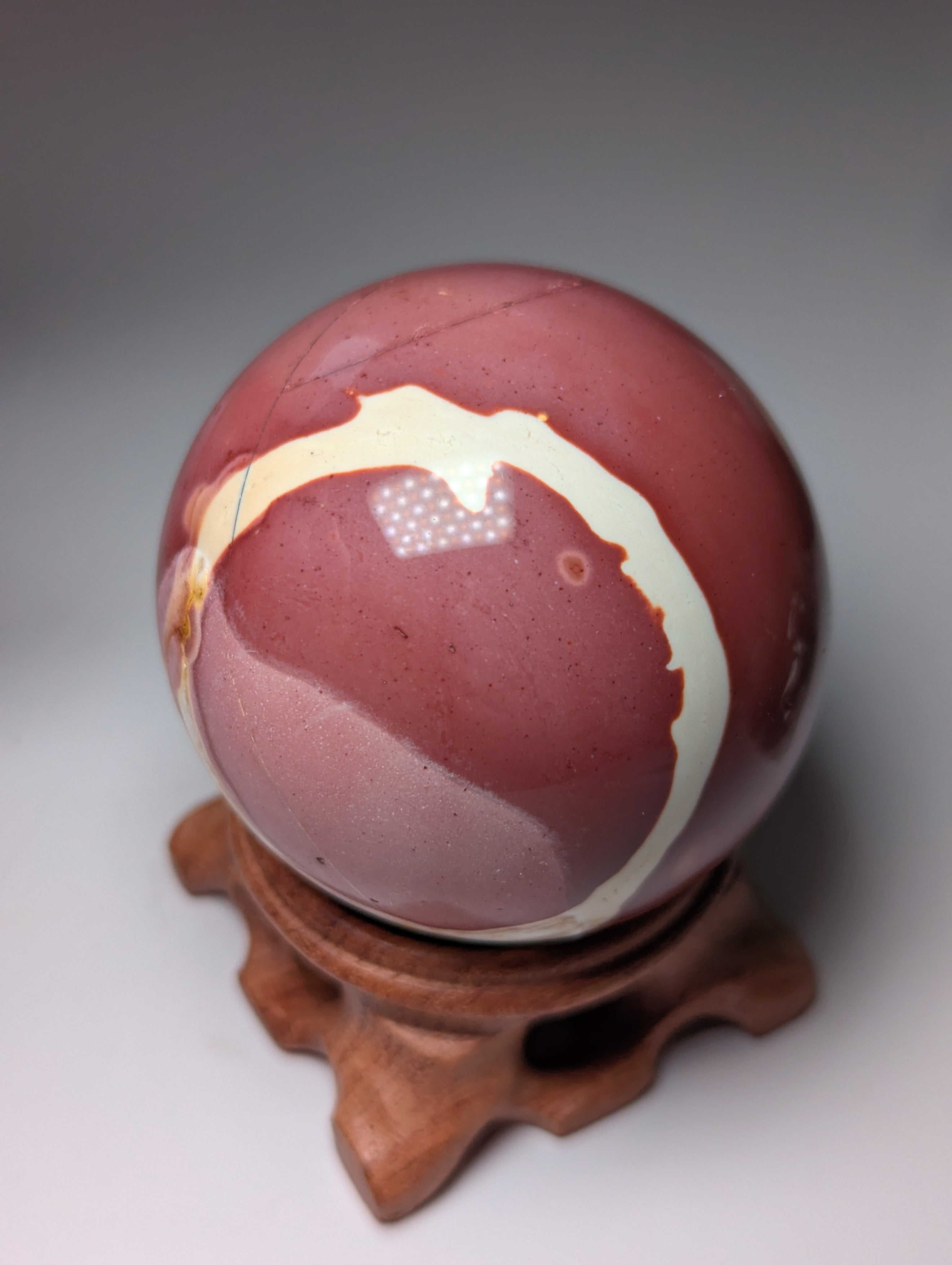 Mookite crystal sphere with stand