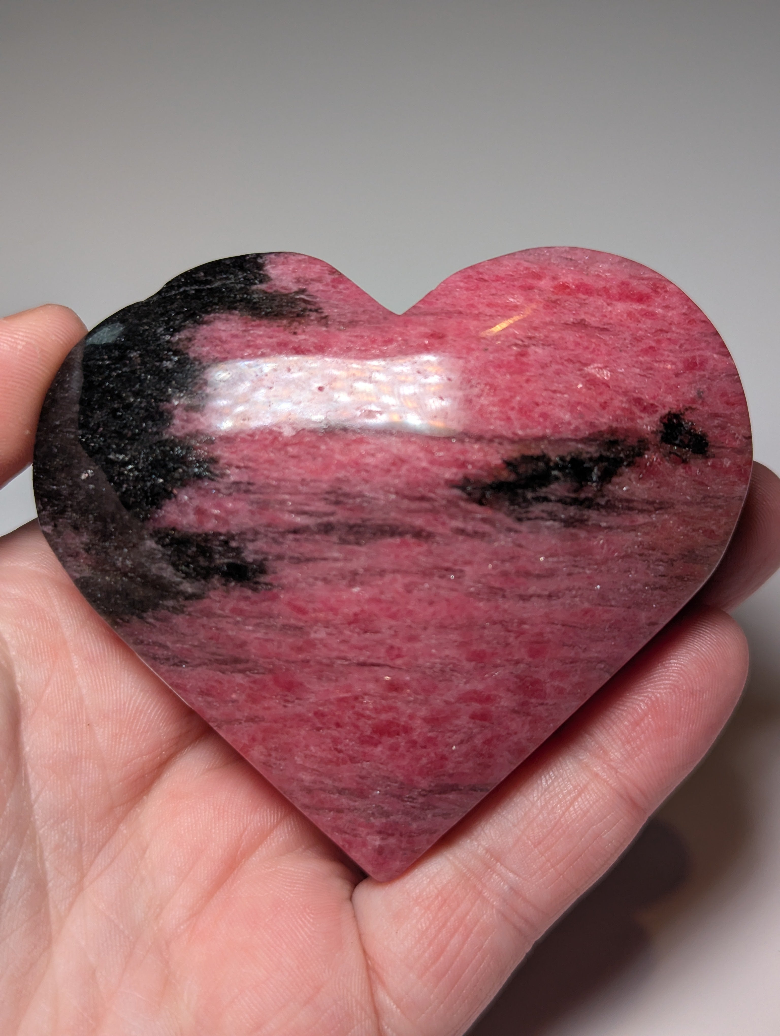 Large Rhodonite crystal heart carving with stand