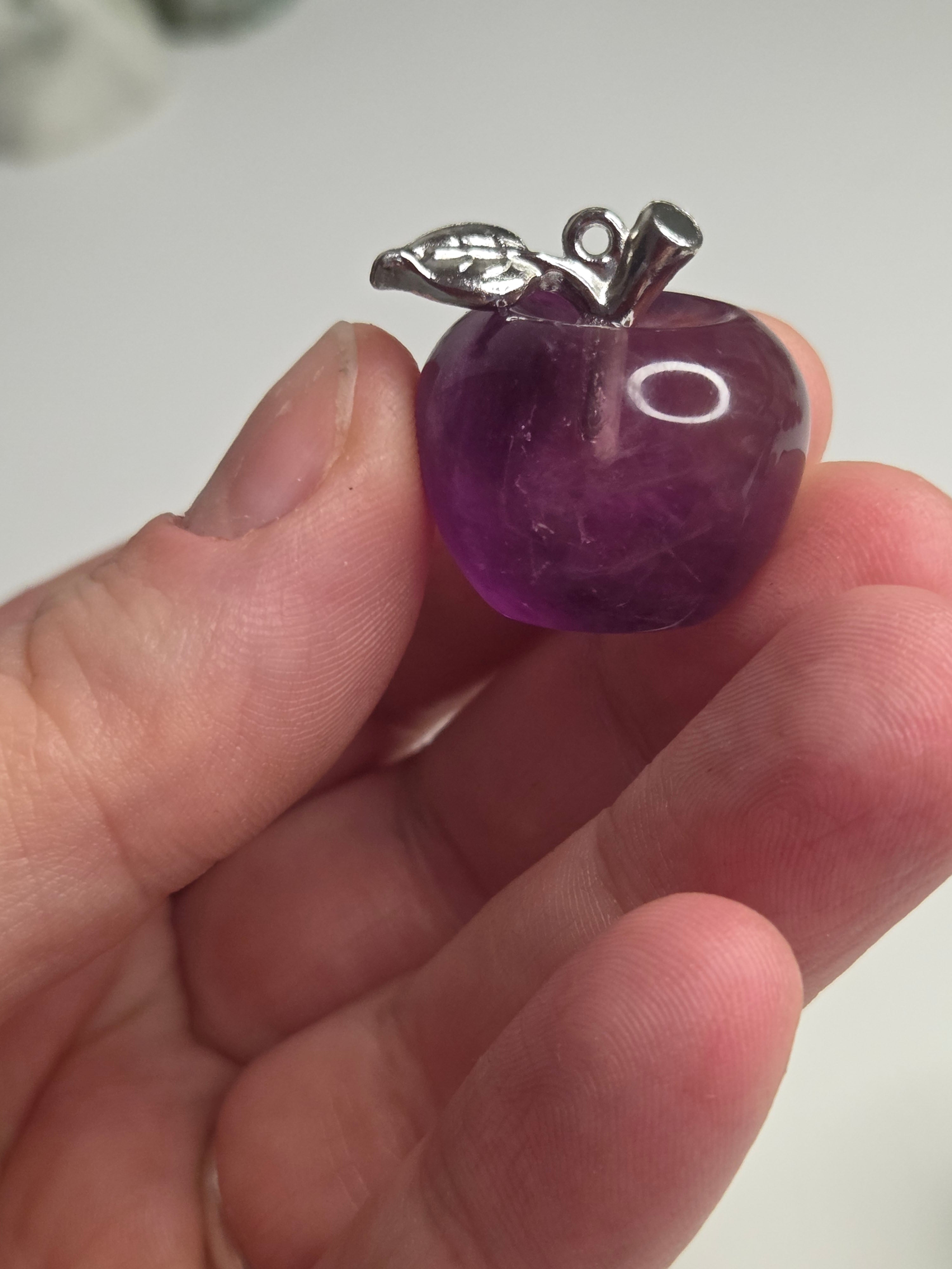 Purple flourite crystal apple carving could be made into a pendant