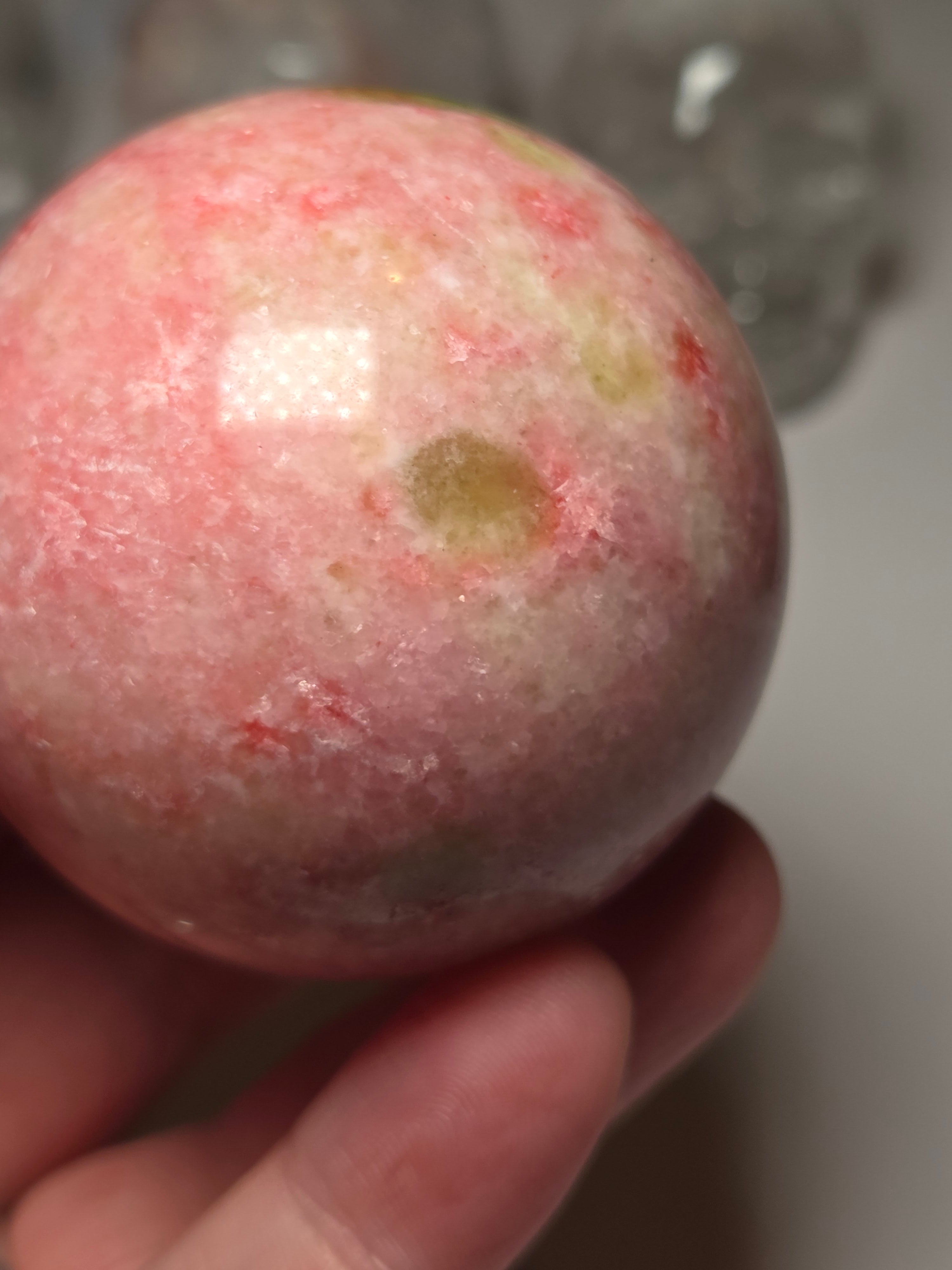 Pink zoisite crystal sphere carving with UV and comes with Stand