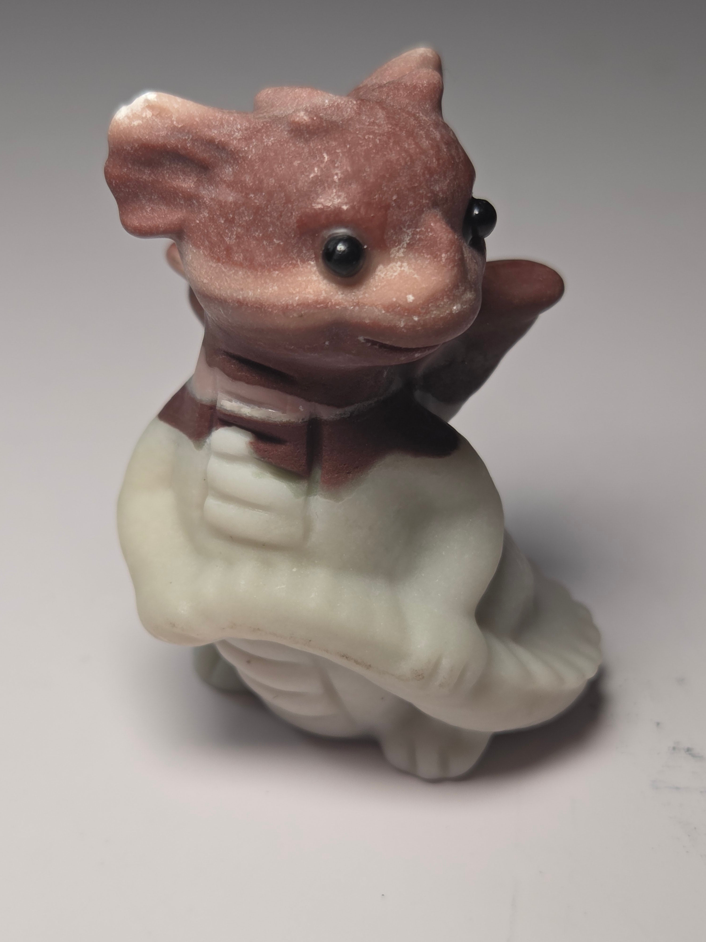 Baby dragon holding tail