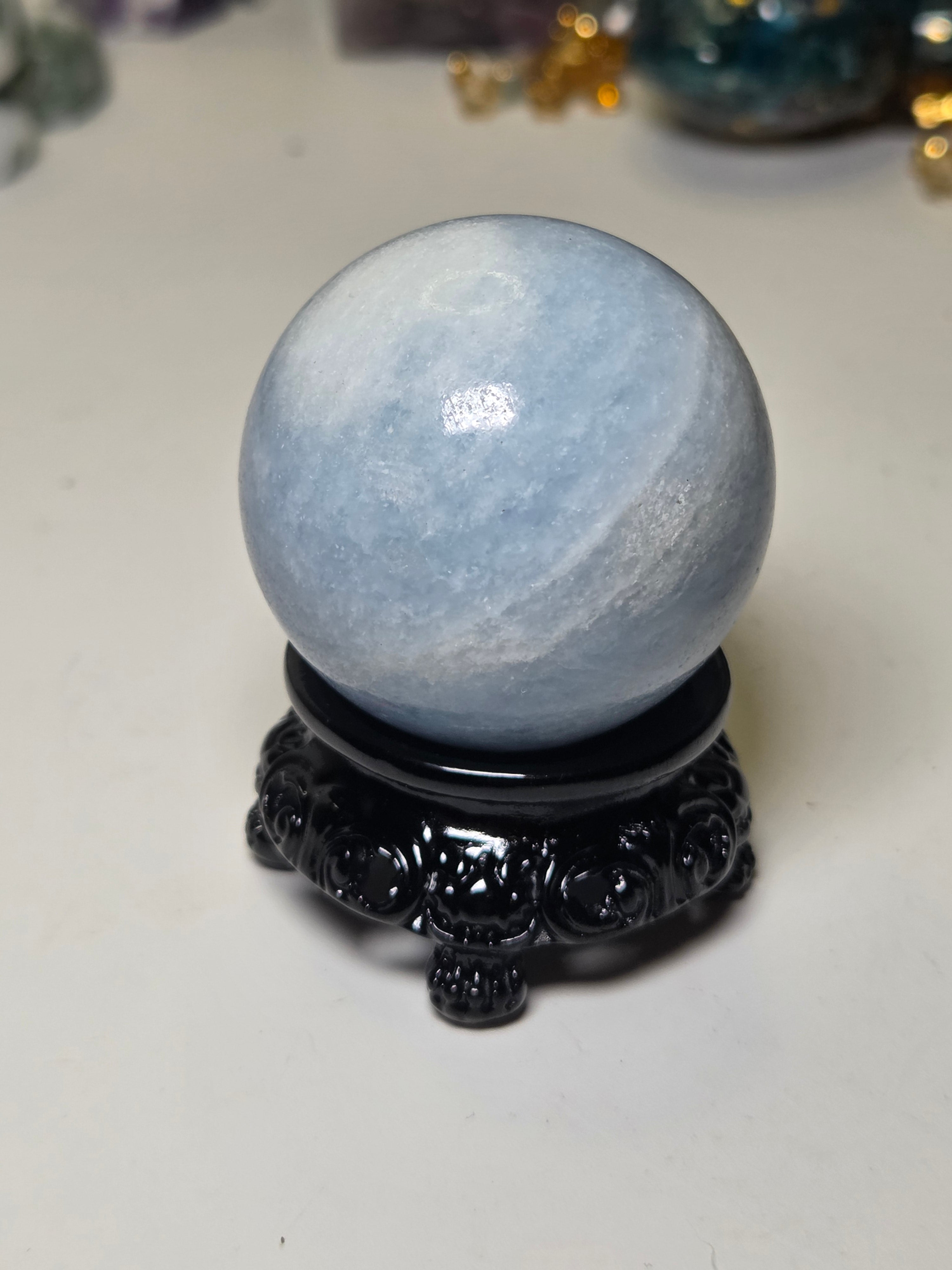 Blue calcite crystal sphere with stand