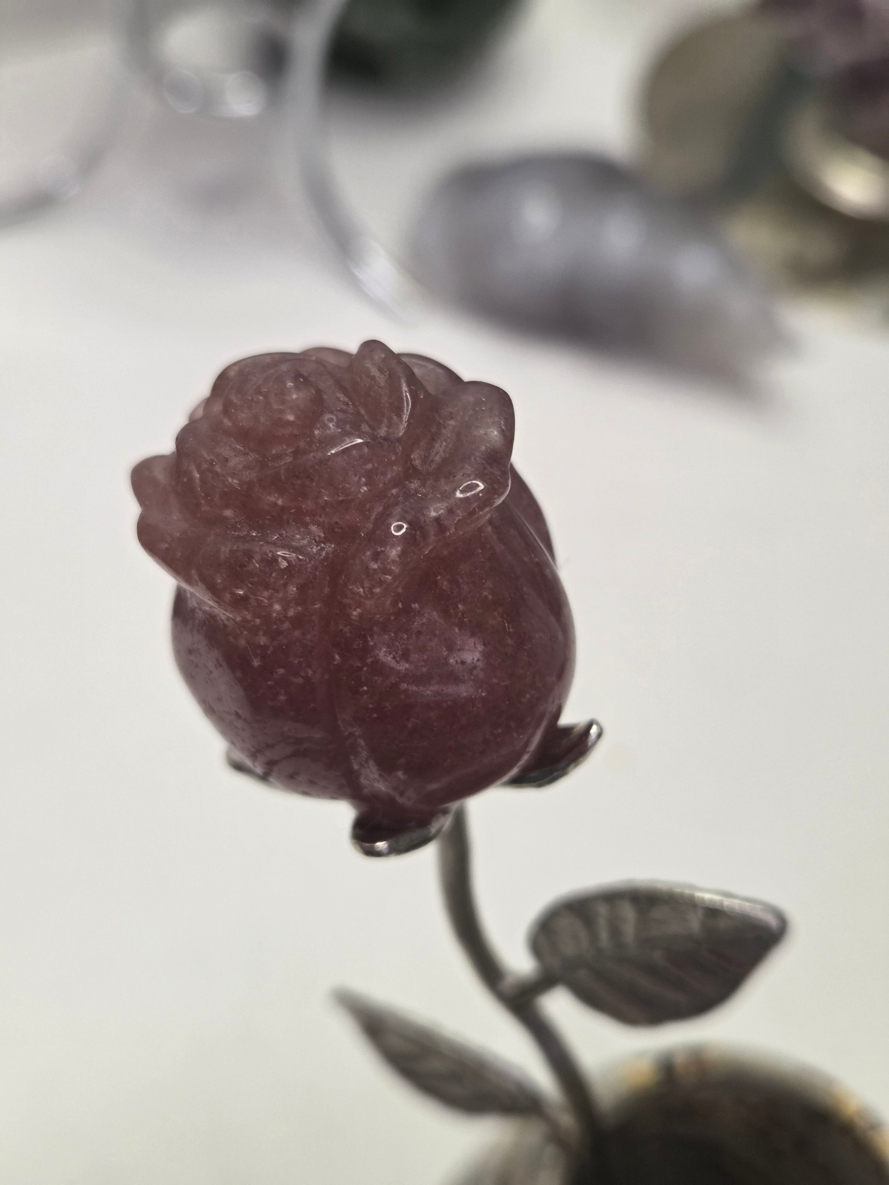 Strawberry quartz crystal rose carving on a stem