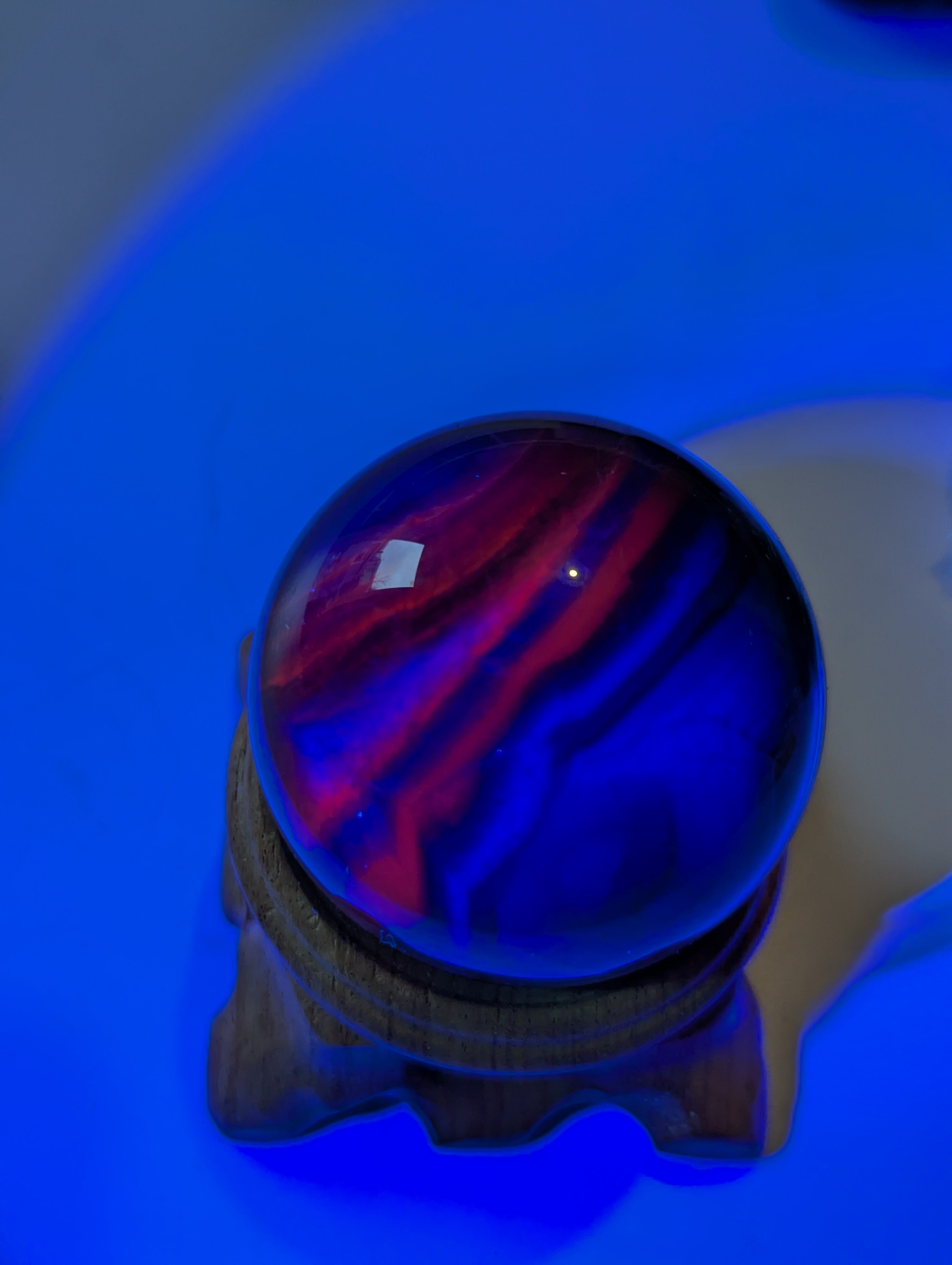 Black flourite crystal sphere with red UV with stand