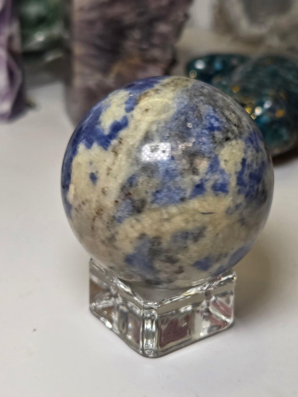 Sodalite crystal sphere carving with stand