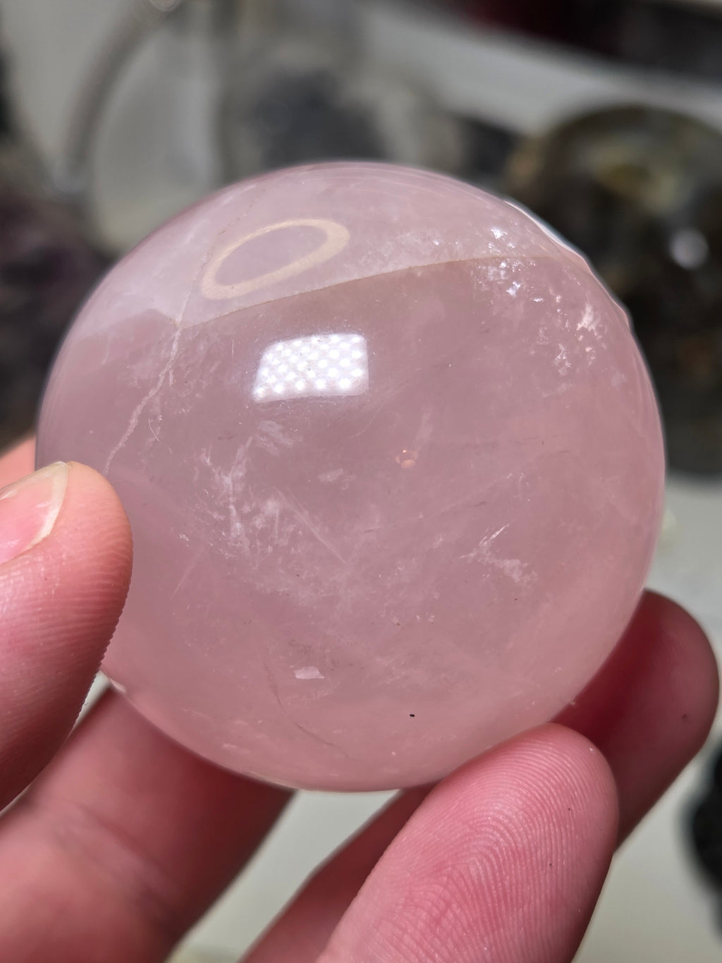 Rose quartz crystal sphere with  crack line and star flash