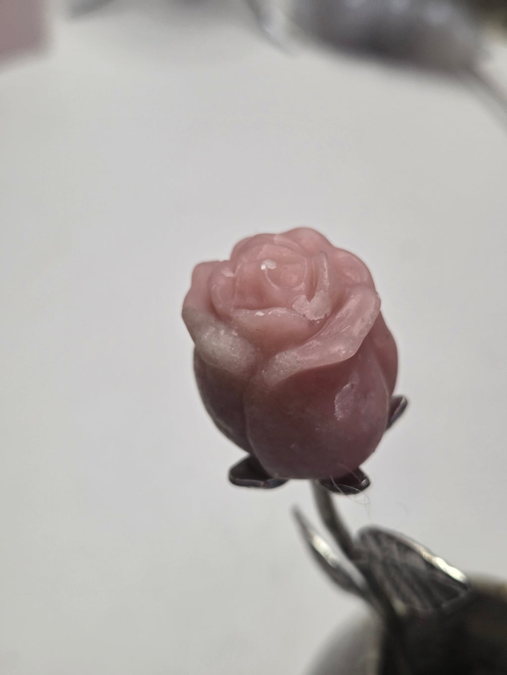 Pink opal crystal rose carving on a stem
