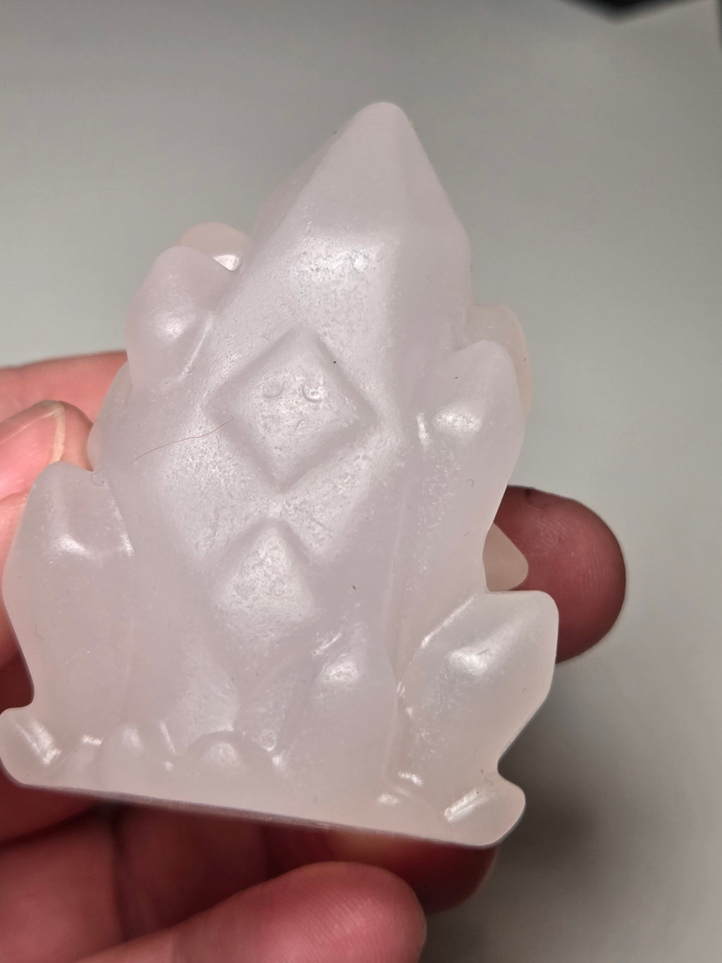 Pink calcite crystal cluster  house carving