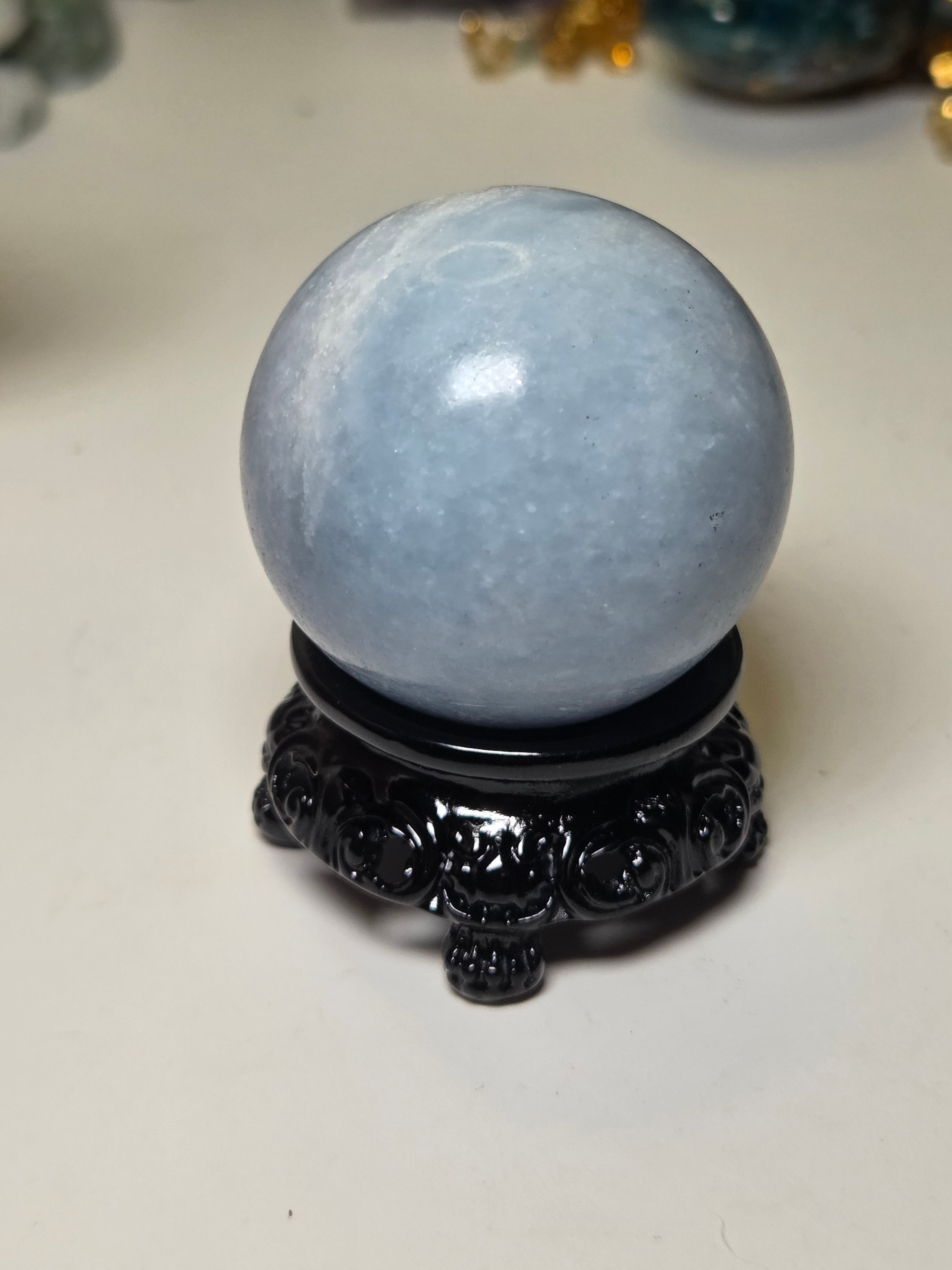 Blue calcite crystal sphere with stand