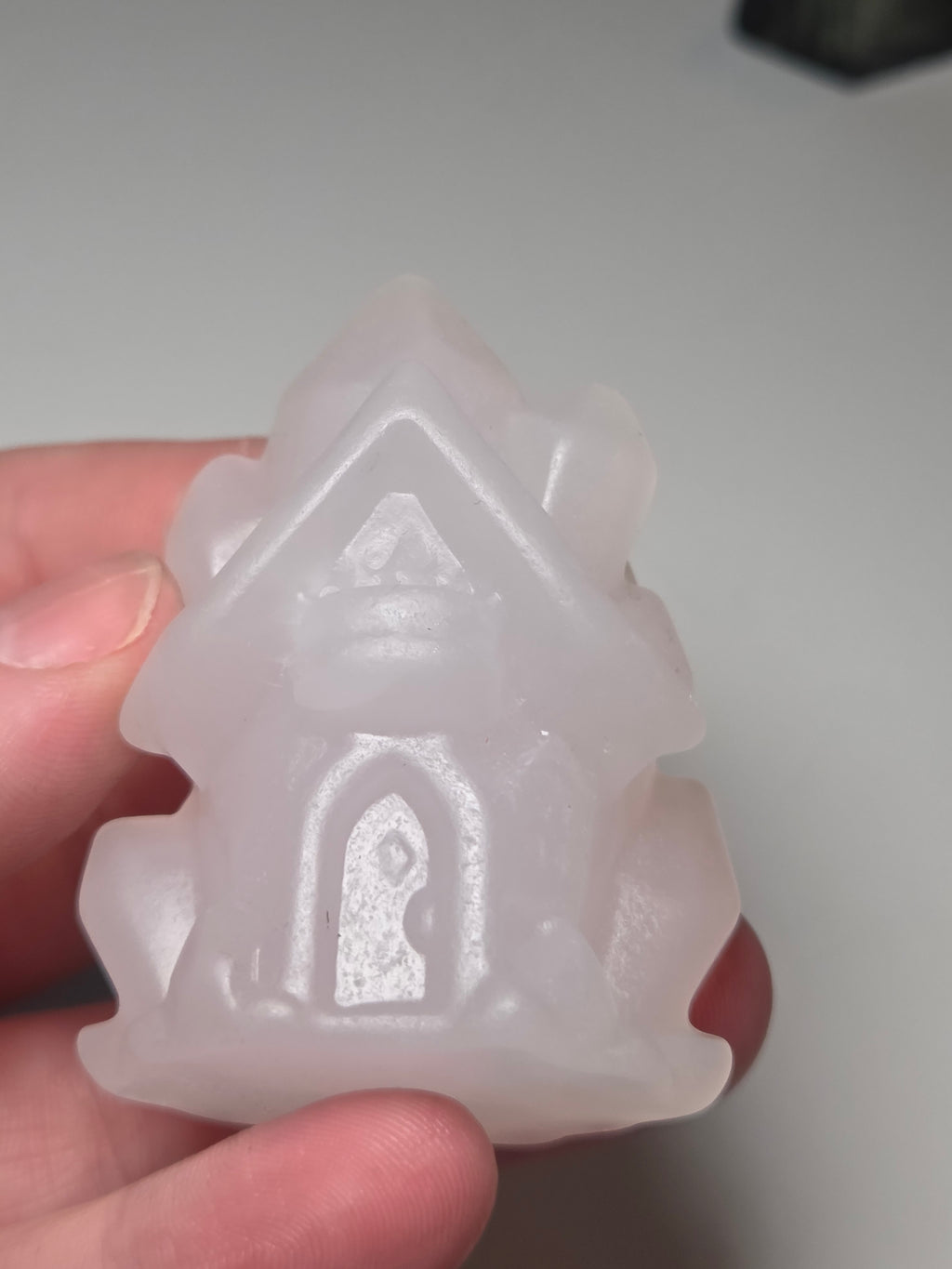 Pink calcite crystal cluster  house carving