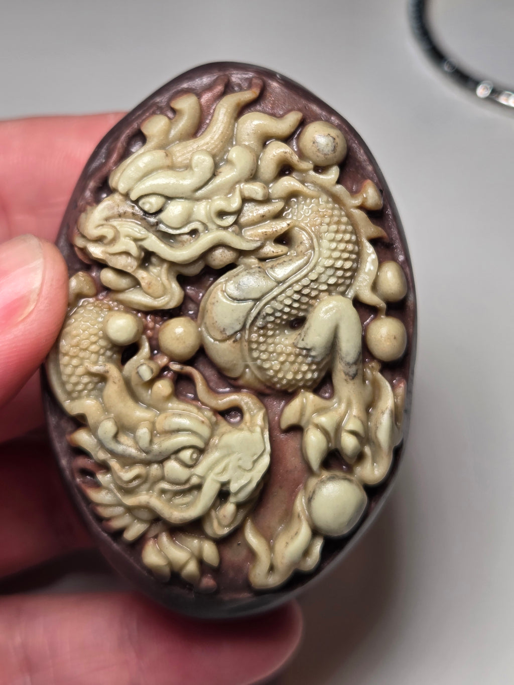Handmade carved dragon palm stone in purple jade from Province